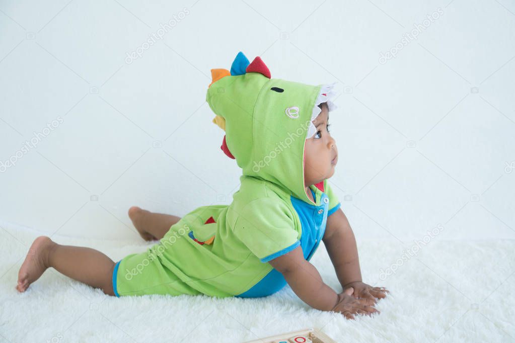 Cute little asian baby in green fancy dress