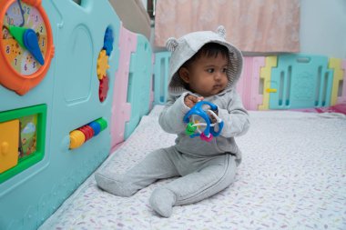 Sevimli küçük asin bebek çocuk oturma ve oyun oyuncak içinde Oda