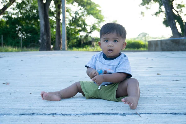 Menino pequeno jogar pau madeira no parque — Fotografia de Stock