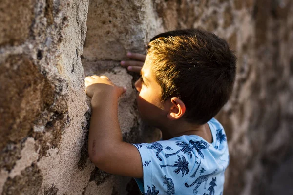Kleiner Junge Blickt Durch Die Mauer Einer Burg — Stockfoto