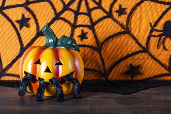 Pumpkin and spider with spider web. Happy Halloween
