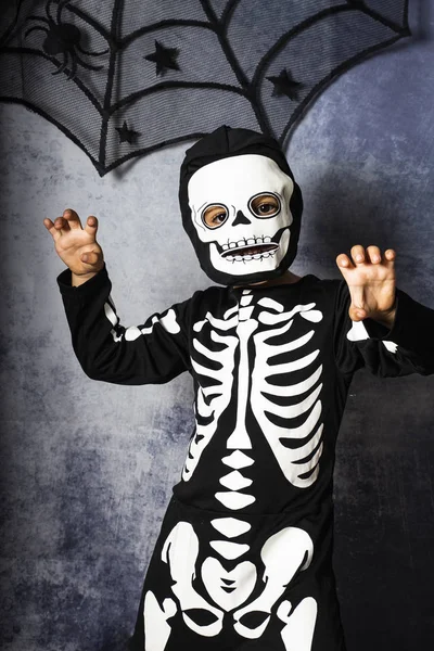 Little kid in a skeleton costume on Halloween Carnival