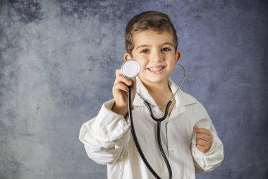 Bir stetoskop ile genç çocuk portresi. Genç doktor