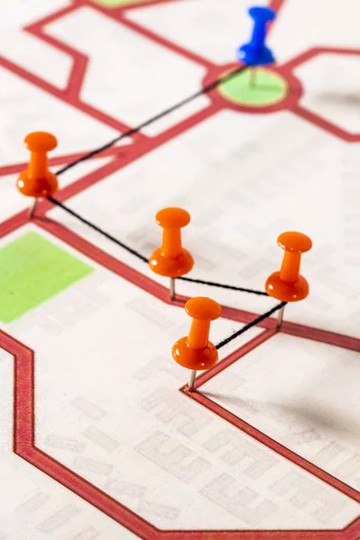 Street map with thumbtacks forming a route