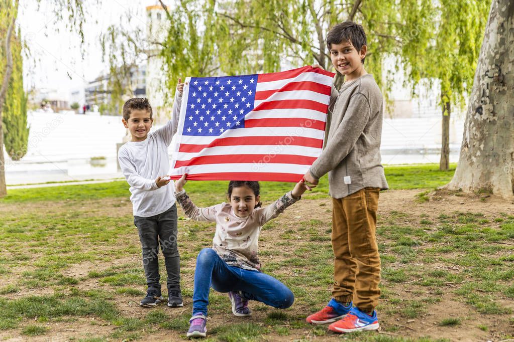 Three kids celebrating 4th of July outdoors
