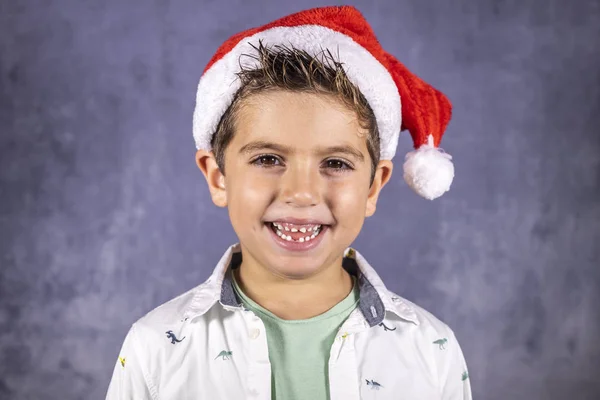 Happy cute child with Christmas hat smiling Royalty Free Stock Photos