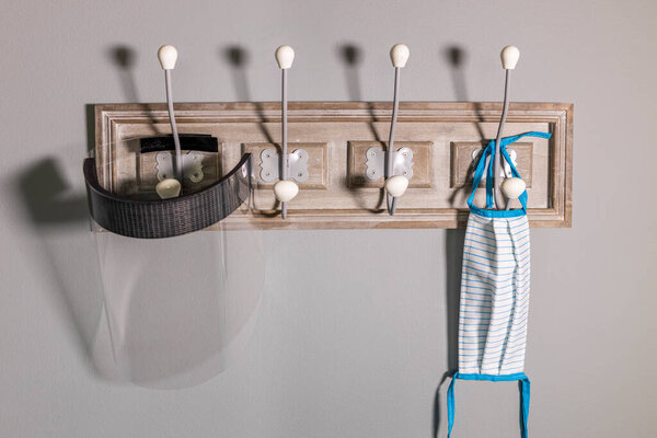 Coat rack with safety mask and protective screen