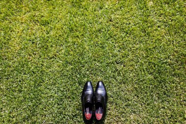 Damadın ayakkabıları siyah. Çimlerin üzerinde yatıyordu. Doğal.