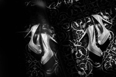 Gelinin halıdaki düğün ayakkabıları. Güneşle aydınlatılıyor. Aynadaki yansıma..