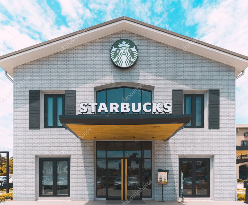 Bangkok, Thailand - May 24, 2018: Starbucks Coffee house branch on sunny day. Starbucks Corporation is an American coffeehouse company, operating 28,218 international coffee shop stores worldwide