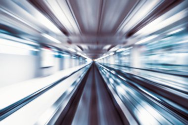 Motion blur abstract background, fast moving walkway or travelator in airport terminal transit, zoom effect, center diminishing perspective. Transportation, warp speed, or business technology concept clipart