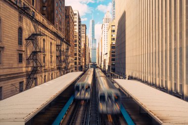 Trains arriving railway station between buildings in downtown Chicago, Illinois. Urban public transportation, USA landmark, or American Midwest city life concept clipart