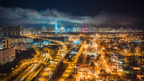 Hong Kong port, highway traffic, and the Symphony of Lights show on buildings in city at night. Asia tourism, travel destination, Asian logistic business, or transportation industry concept