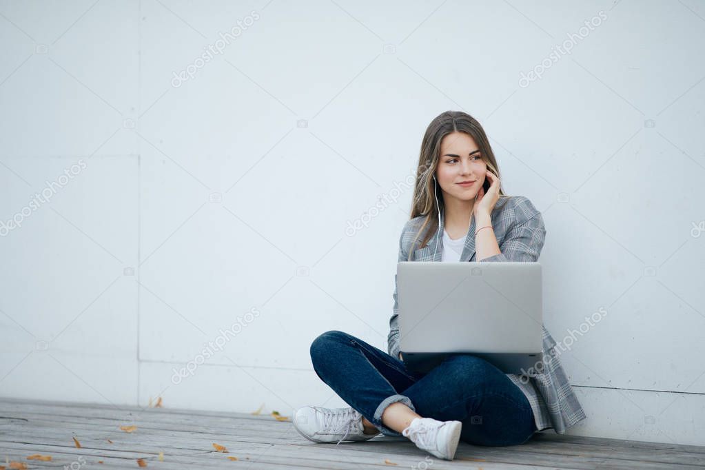 Pretty girl sit with her laptop and stydy. White background