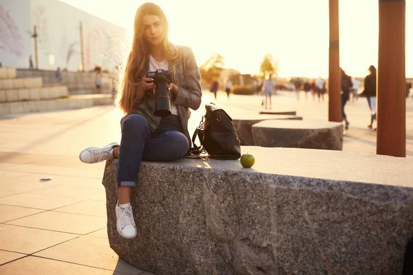 Fotograf Dívka Sedí Skále Vzhled Její Fotoaparát — Stock fotografie