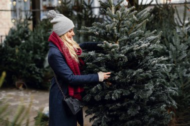 Ağaç Dükkanı, açık satın almak için mükemmel Noel ağacı güzel sarışın kız. El onay için kalite, kopya alanı - görüntü kullanan kız