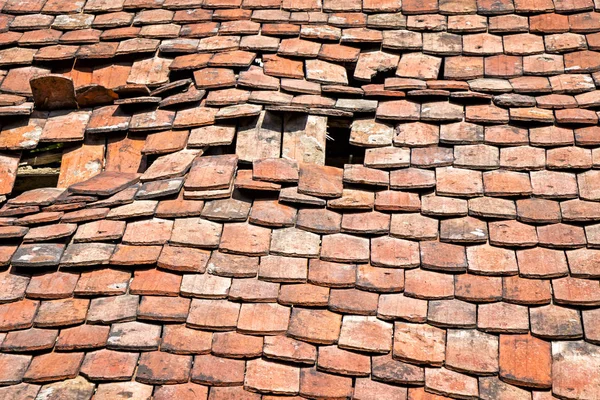 Damaged roof with old roof tiles. Was seen in Brandenburg