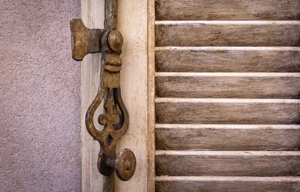 Detail of a metal window fitting. Seen in a village in Provence. — Stock Photo, Image