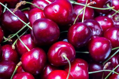 beyaz bir tabak üzerinde olgun kırmızı kiraz