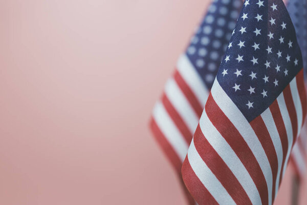 Flags United States of America with vintage pink background empty space for your text on left.