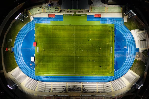 Football stadium at night light, top down view on soccer players.