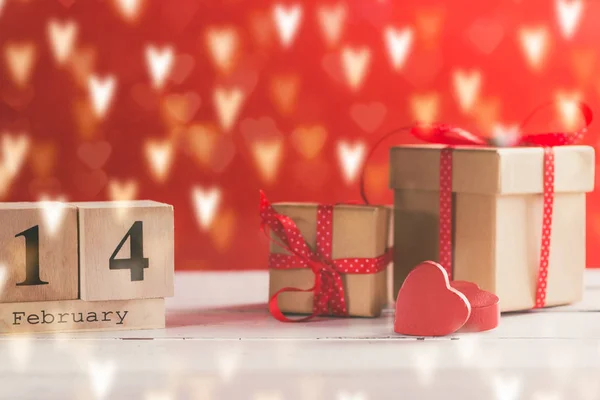 Concept photography of Valentine\'s gift with wooden calendar shows the date 14 february.