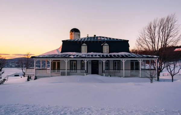 Farm in winter time in Canada at sunset. Orlean island. Nobody