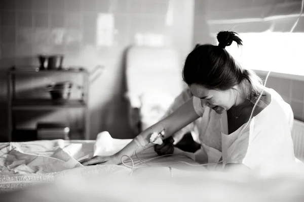 Young  pregnant woman before giving birth in a hospital  ward.Black and white