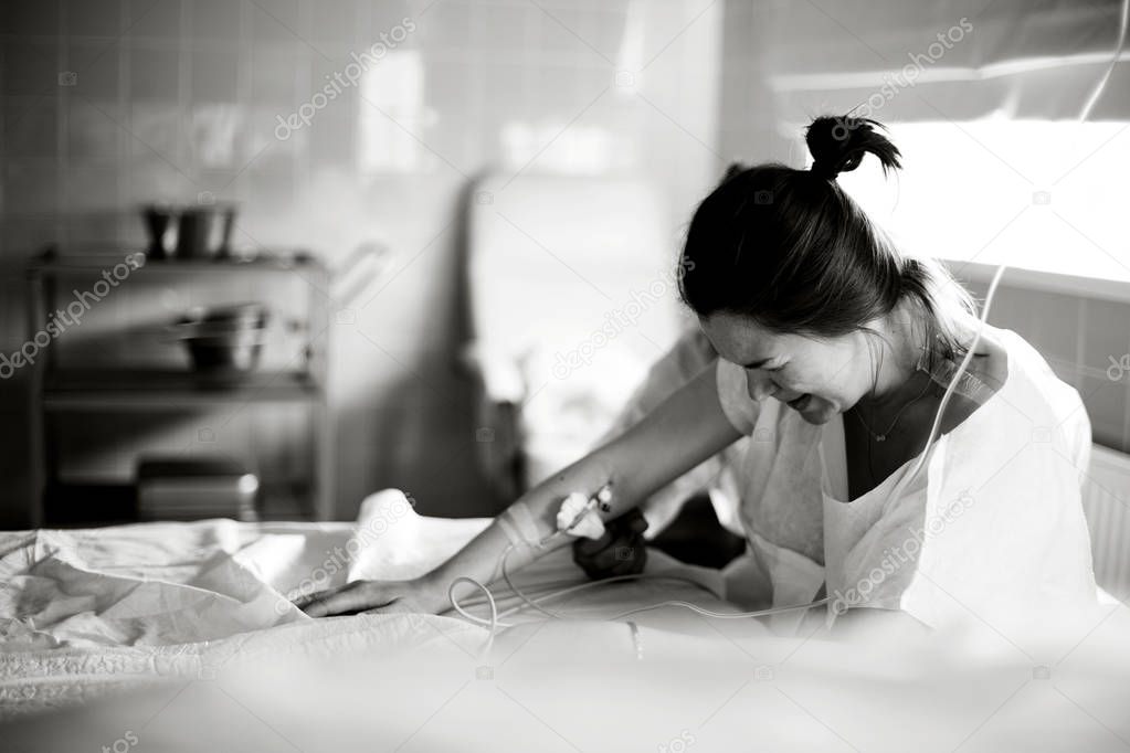 Young  pregnant woman before giving birth in a hospital  ward.Black and white