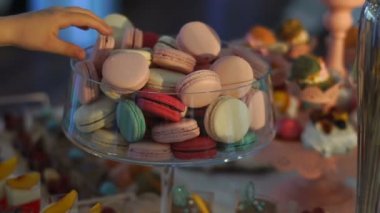 Tatlı stand macarons düğün masada farklı renk dolu. El kurabiyelerden alıyor.