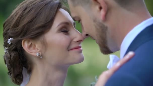 Nahaufnahme sensibles Porträt des erstaunlichen glücklichen Brautpaares in Liebhabern, die sich sanft die Nase reiben. — Stockvideo