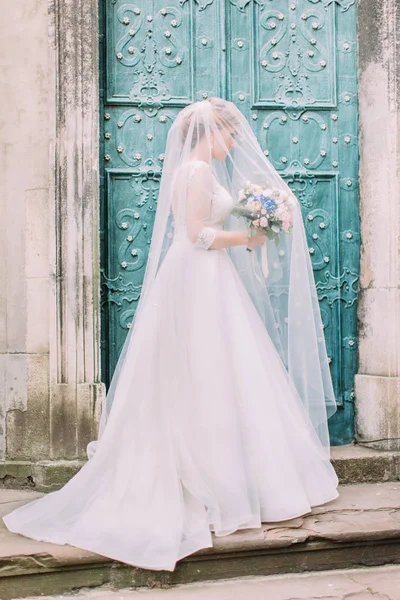 Внешний вид стильной невесты с букетом под вуалью . — стоковое фото