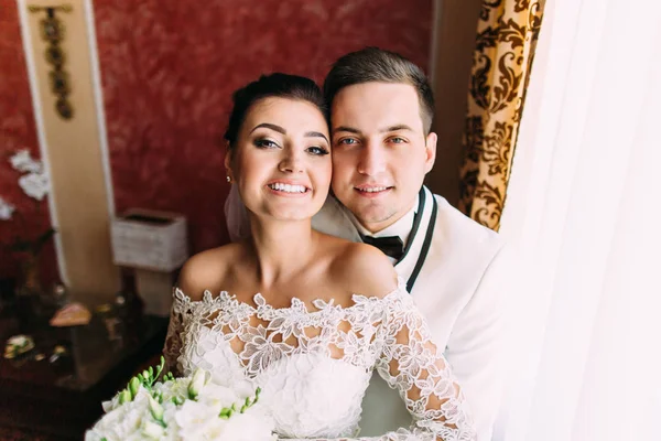 Close-up πορτρέτο του χαμογελώντας γαμπρού αγκαλιάζει την ευτυχισμένη νύφη πίσω. — Φωτογραφία Αρχείου