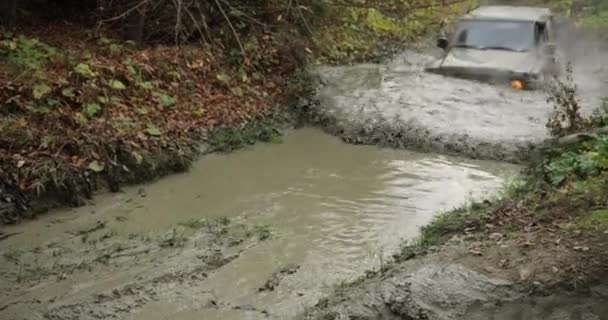 Tempo libero di montagna. Vocazioni autunnali. Estremo. Auto fuoristrada Mitsubishi Pajero guida veloce nella palude sulla collina da qualche parte in montagna autunno e ottenere stucchi — Video Stock