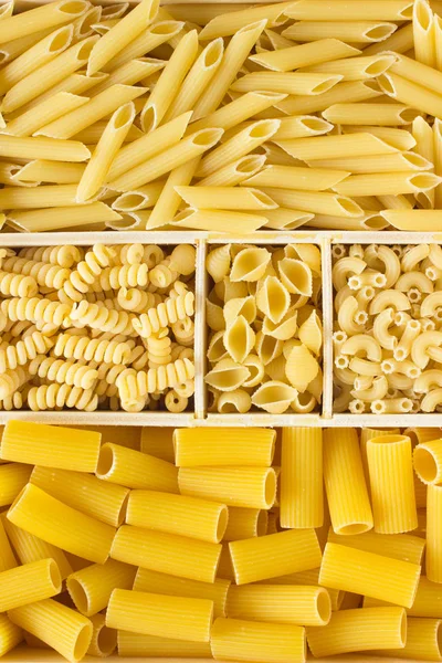Different kinds of pasta in a wooden box