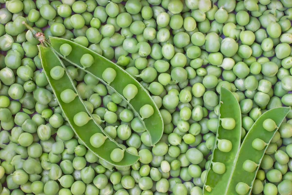 Green peas and pea pod close up. Top view. Food backgroun