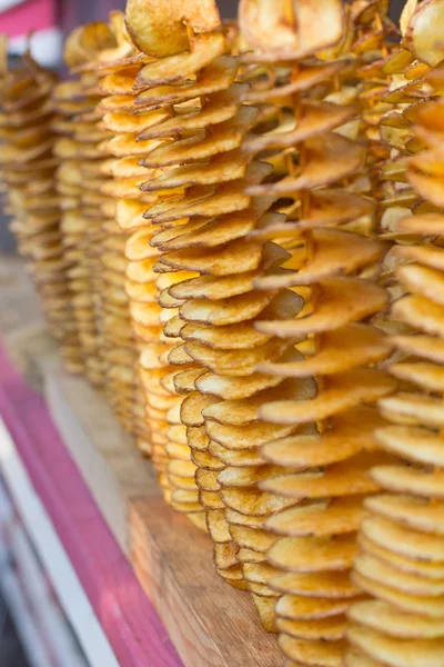 Lezzetli patates cipsi ince tahta sopa üzerinde. Dikey çerçeve. Arka plan bulanıklık