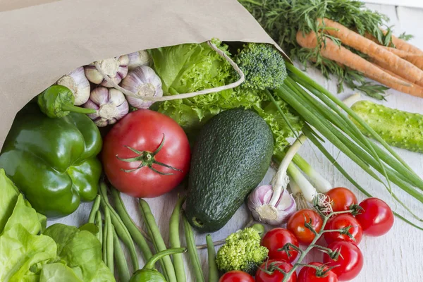 Healthy food in paper bag of different  vegetables on white background. Top view