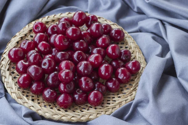 Cerise mûre dans une assiette en osier. Vue de dessus. Dosseret alimentaire — Photo