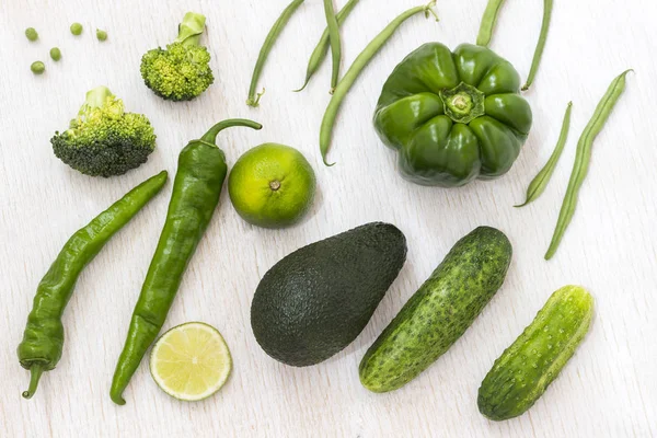Набор зеленых овощей: спаржа, перец, брокколи, авокадо на белом фоне. Вид сверху — стоковое фото