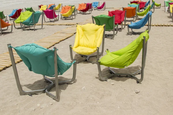 Armchairs with soft pillows on the sandy shore. Rest zone — Stock Photo, Image