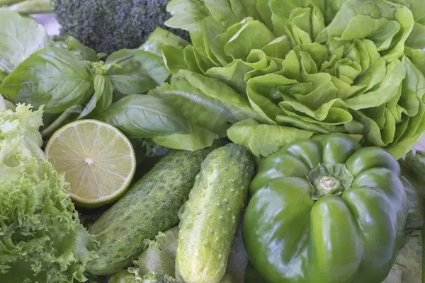 Healthy green vegetables: broccoli and cucumbers, lettuce, onions and peppers