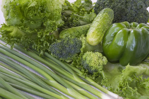 Healthy green vegetables: broccoli, lettuce, onions and pepper Royalty Free Stock Images