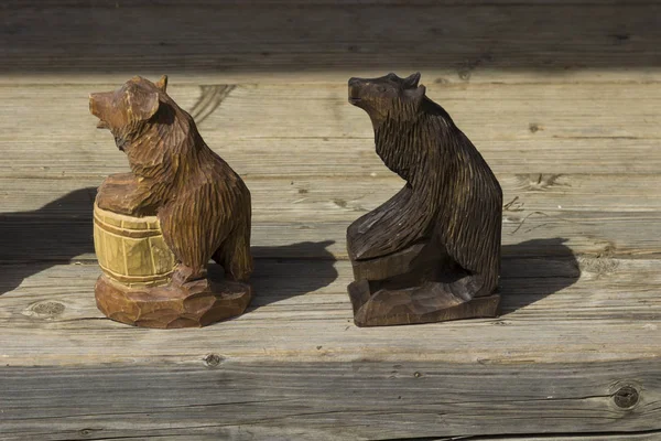 Wooden figures of two bears on a wooden floor, handmade