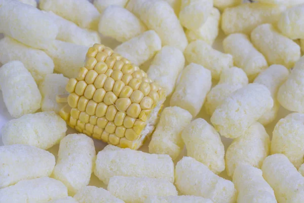 Corn cobs among corn sticks, top view