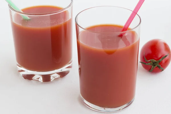 Two glasses of tomato juice on a white background — Stock Photo, Image