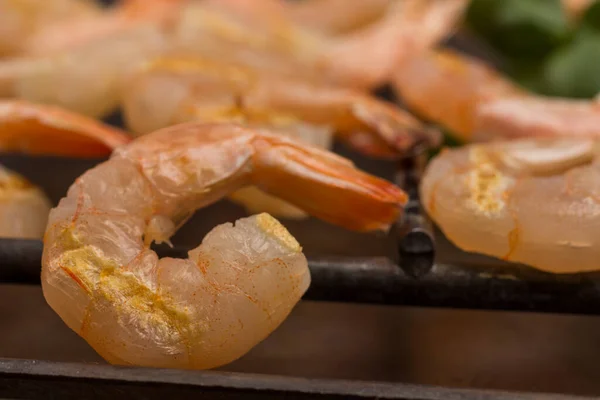 Tiger shrimps on metal grill close up. Grilled seafood.  Healthy nutrition