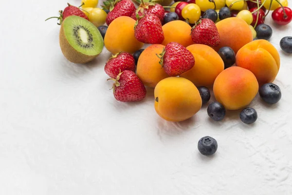 Assorted Fresh Berries Fruits Apricots Kiwi Strawberry Cherry Blueberry White — Stock Photo, Image