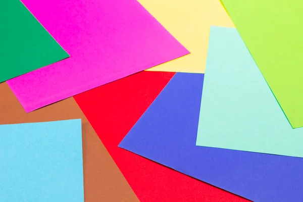 Colorful papers geometry flat composition background. Flat lay. Close up