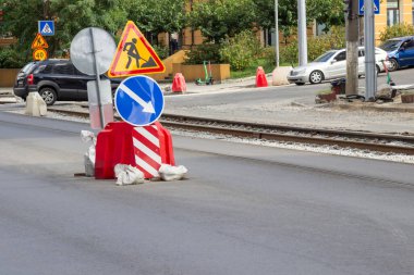Road warning signs during road repairs. Motor vehicles on the road.